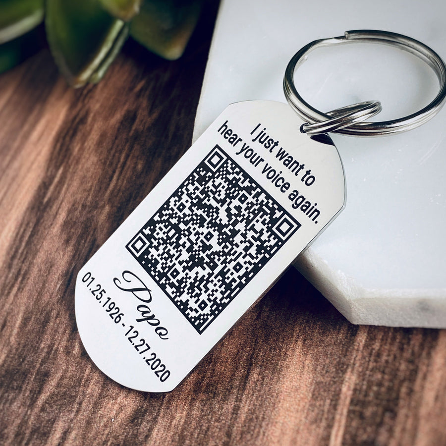 silver stainless steel dog tag keychain engraved with the quote "I just want to hear your voice again.". Then a voicemail QR code. Underneath the qr code is the name Papo, date of birth 01.25.1926 and death date 12.27.2020