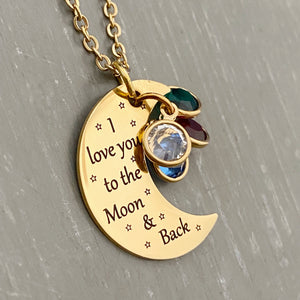 yellow gold half moon charm with black engrave tiny stars and the saying "I love you to the moon & back". attached to the moon are a april, june, may, and february birthstone. The moon birthstone necklace hangs from a yellow gold cable chain.