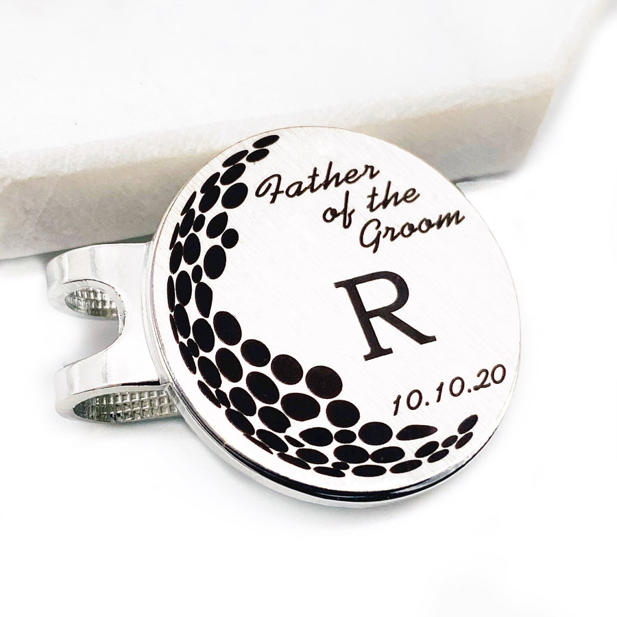 1 inch golf marker with hat clip engraved with "Father of the Groom" initial "R" and the date "10.10.20"