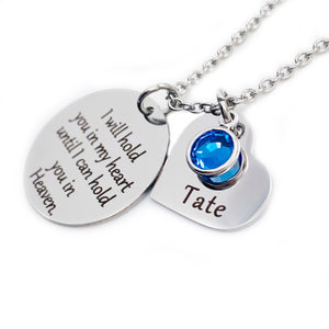 One 1-inch silver stainless steel disc engraved with "I will hold you in my heart until I can hold you in Heaven" Along side is a 3/4" silver heart engraved with "Tate" and a september blue birthstone. Both pendants are attached to a stainless steel cable chain with lobster clasp.