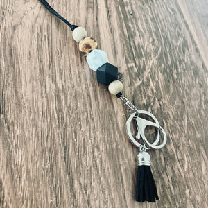 cheetah, marble, black silicone beaded lanyard with round key ring and lobster claw keychain and matching black tassel.