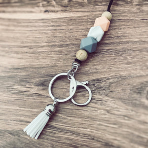 coral, marble, grey silicone beaded lanyard with round key ring and lobster claw keychain and matching white tassel.