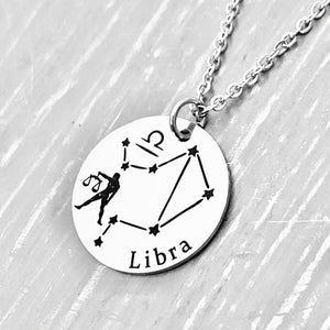 silver stainless steel 7/8" disc engraved with Libra, its constellation, symbol, and the Scales attached to a stainless steel cable chain with lobster clasp