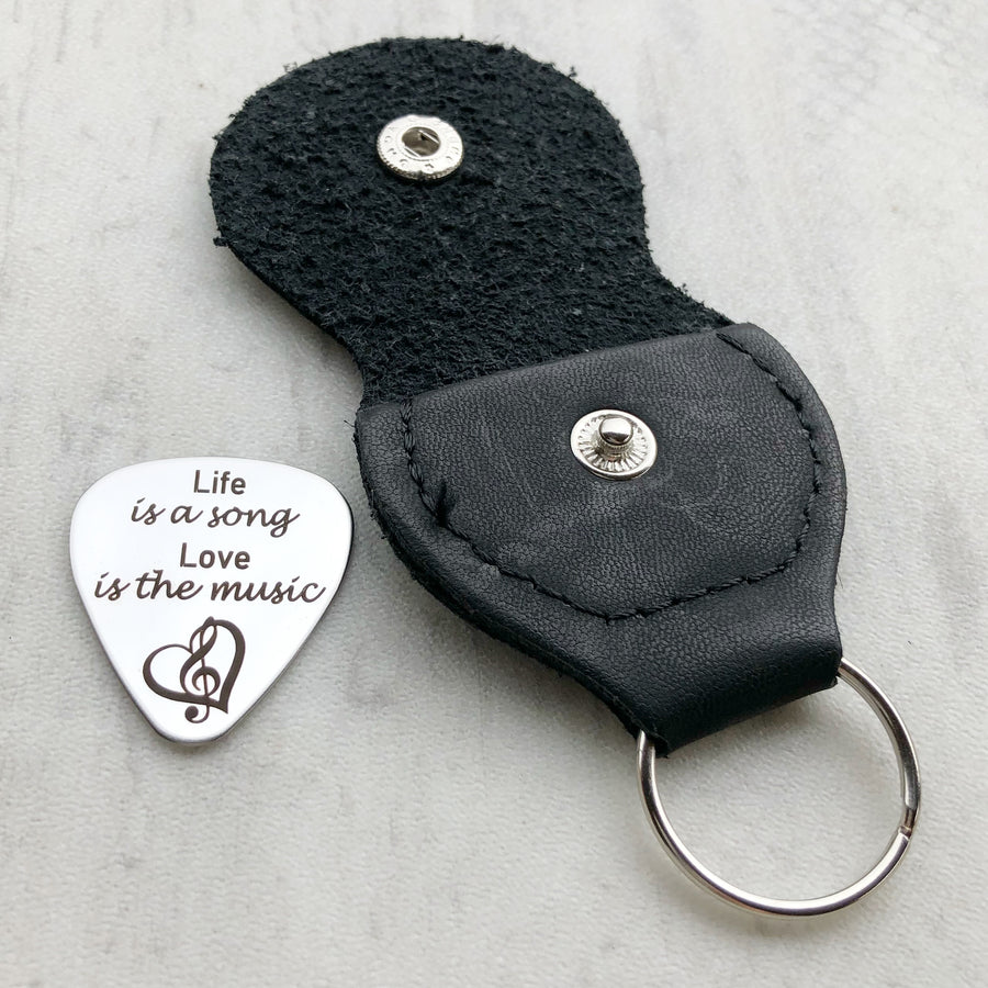 guitar pick with black leather keychain case