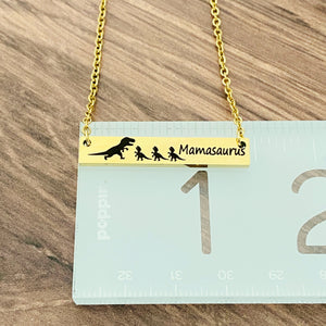 Dinosaur bar necklace on ruler to show 1 3/8" length