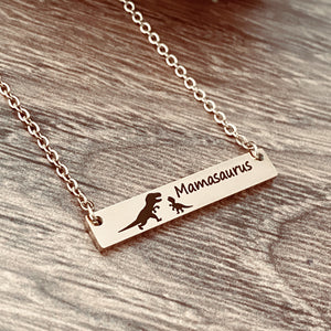 Rose Gold Horizontal Bar necklace engraved with "Mamasaurus" and a Mom trex dino and a baby dino