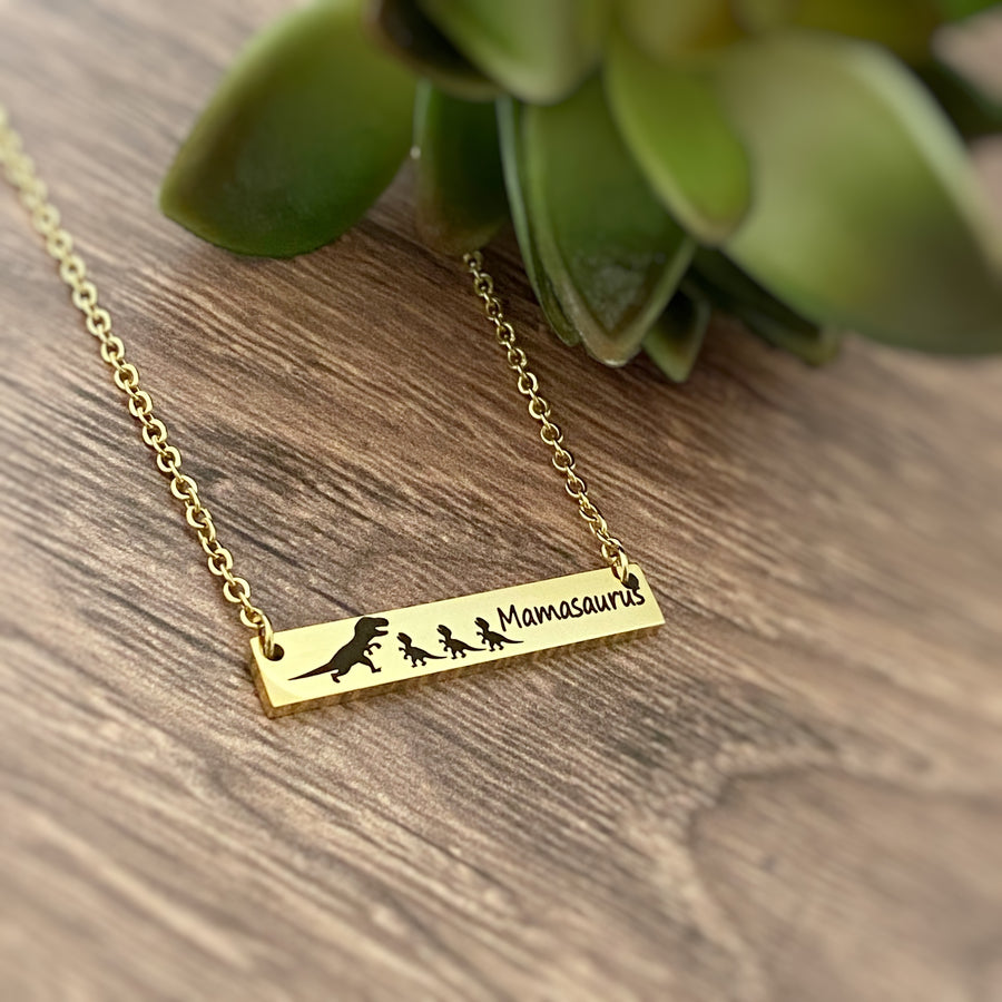 Yellow Gold Horizontal Bar necklace engraved with "Mamasaurus" and a Mom trex dino and 3 baby dinos