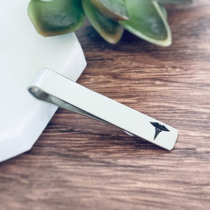 silver engraved tie bar clip engraved with a medical caduceus symbol