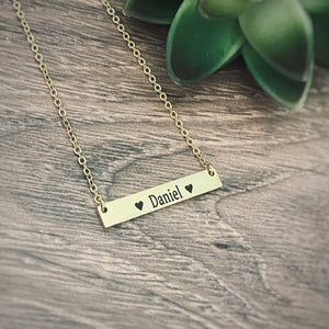 yellow gold horizontal bar necklace engraved with the  children's name Daniel