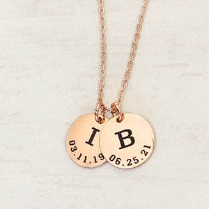 rose gold 2 disc pendant necklace with the initials I and B and date of birth engraved 3.11.19 and 6.25.21