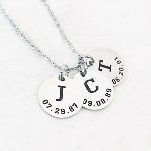 3 round 5/8 pendant discs. first disc engraved with J and date of birth 7.29.87. second disc engraved with C and the date 9.8.89. the third disc engraved with T and the date 6.20.91