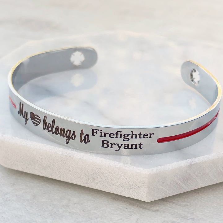 Silver stainless steel cuff bracelet with maltese cross fireman cutout symbol with engraved my american flag heart shape belongs to firefighter bryant