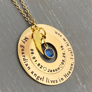 Yellow Gold double pendant necklace. The outside circle is 1.25 inch is engraved with "my guardian angel loves in heaven, I call him son". the middle 1 inch circle is engraved with 09.01.82 an open heart image, the name jason, an open heart image, and the death date 08.25.19. The center dangles with a blue September stone. attached is an angel wing charm. all pendants and charms are connected to a cable chain with lobster clasp.