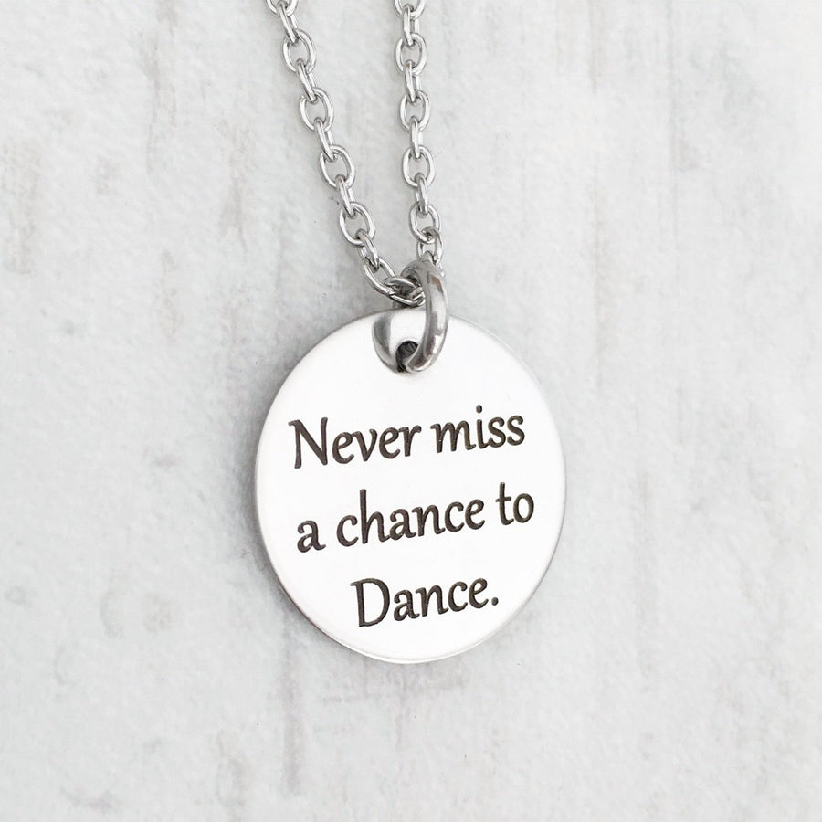 .75 inch silver stainless steel round disc engraved with "never miss a chance to dance" 