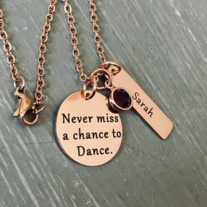 .75 inch rose gold stainless steel round disc engraved with "never miss a chance to dance" a 6mm april birthstone and a 1.2 inch rectangle tag engraved with the name sarah