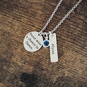 .75 inch silver stainless steel round disc engraved with "never miss a chance to dance" a 6mm December blue birthstone and a 1.2 inch rectangle tag engraved with the name Alyssa