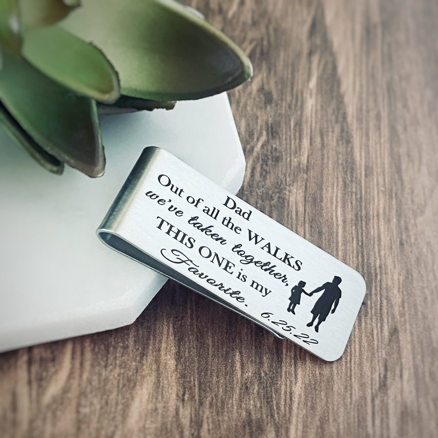 silver stainless steel engraved 1" x 2" father of the bride wedding money clip engraved with "Dad. Out of all the walks we've taken, this one is my favorite" with a silhoutte of dad and young daughter holding hands walking. wedding date 6.25.22