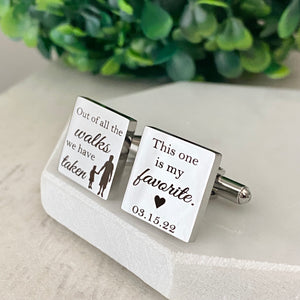 Front view of a pair of silver square engraved cufflinks the first saying "out of all the walks we have taken" with a silhoutte of a daddy holding hands with his little girl.  The other cufflink is engraved with "this one is my favorite and wedding date 03.15.22