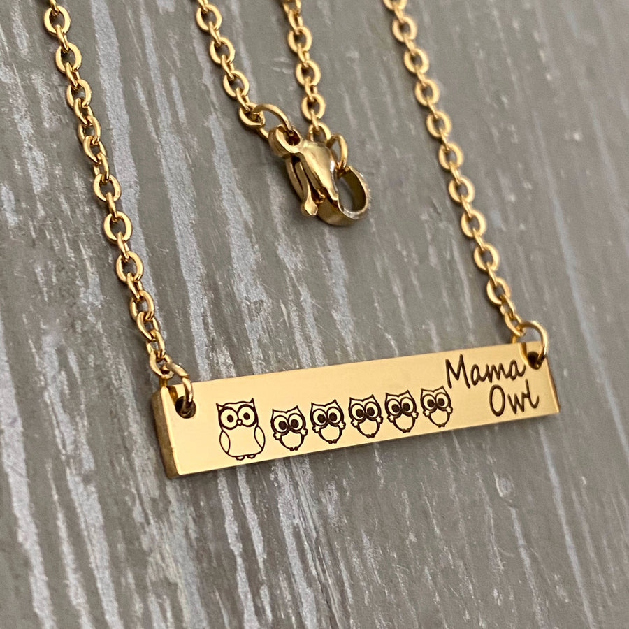 Mama Owl and 5 owlets engraved on a yellow gold bar necklace.