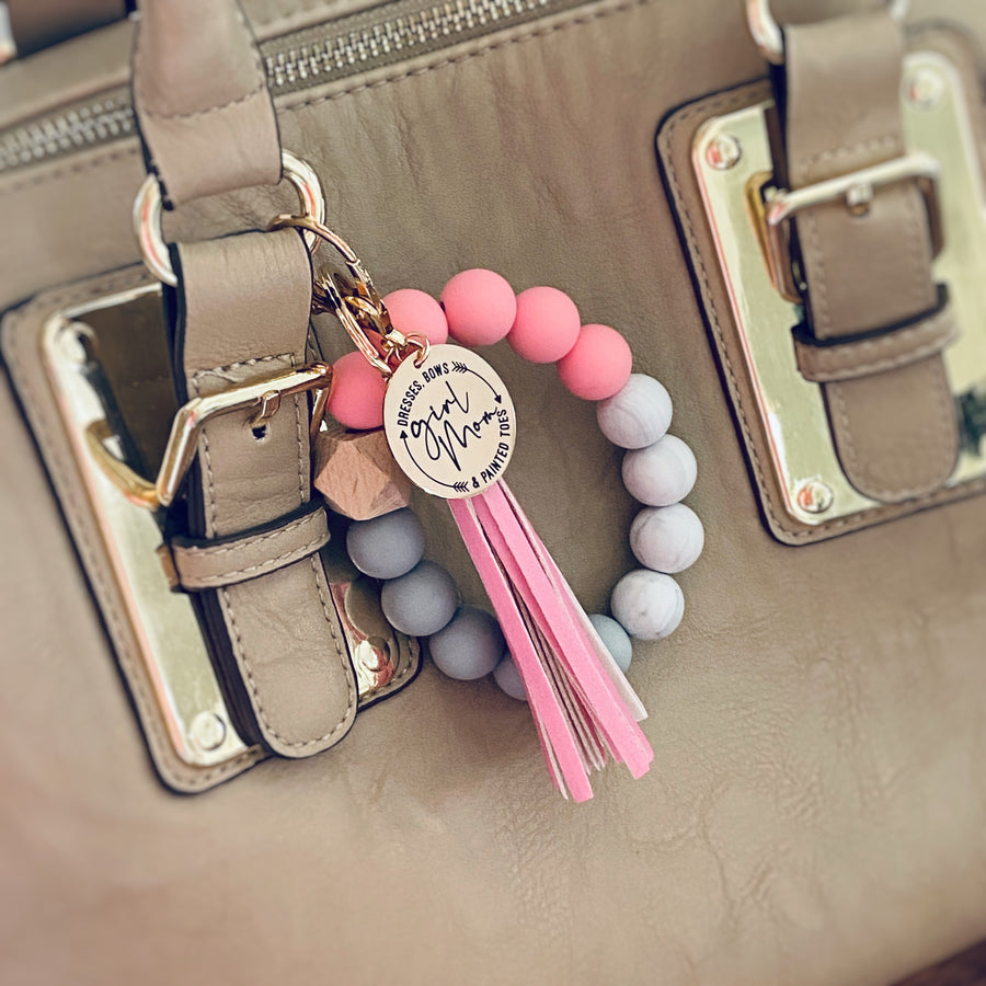pink wristlet attached to a purse handle using the lobster clasp keychain