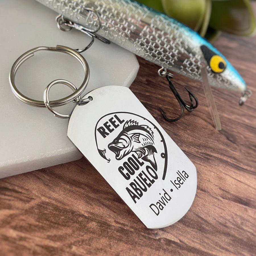 silver dog tag keychain engraved with a bass fish, fishing pole, and "Reel Cool Abuelo" along with children's names
