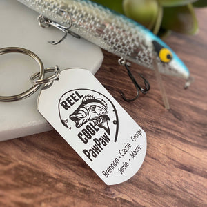 silver dog tag keychain engraved with a bass fish, fishing pole, and "Reel Cool PawPaw" along with children's names