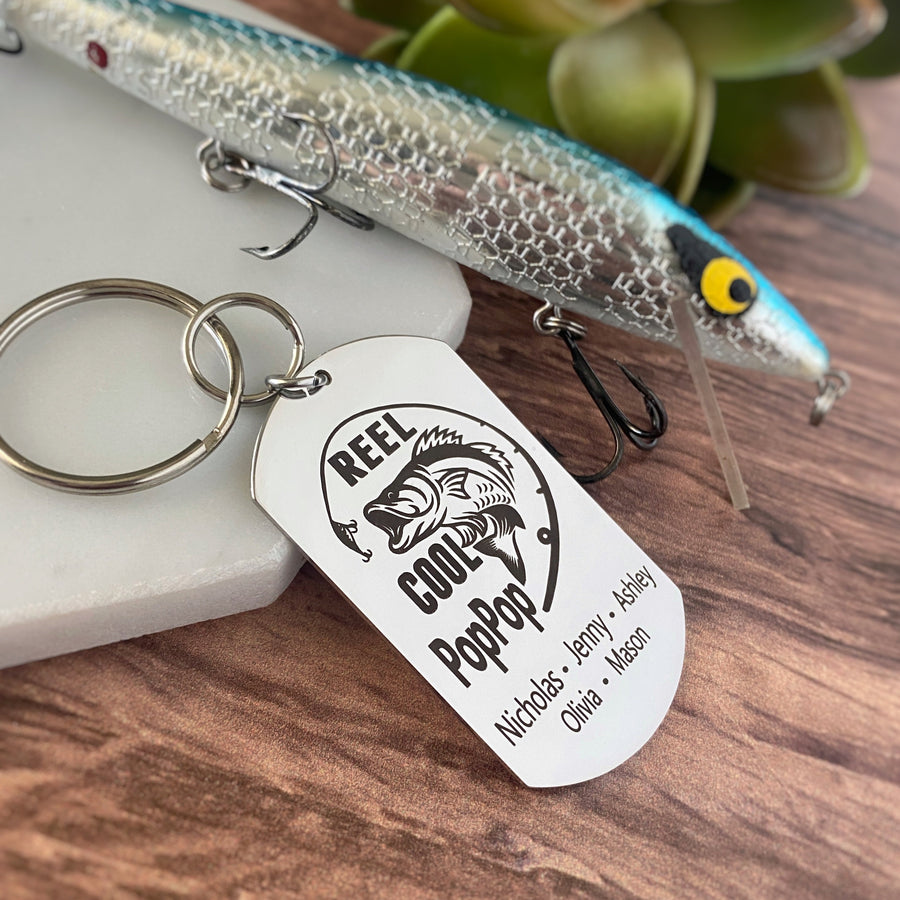 silver dog tag keychain engraved with a bass fish, fishing pole, and "Reel Cool PopPop" along with children's names
