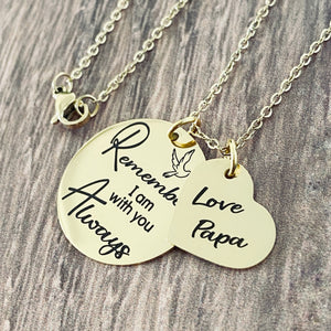 Yellow Gold Memorial Necklace engraved with a dove bird and the phrase "Remember I am with you Always". next to the round pendant is a heart charm engraved with "Love Papa" both charm pendants are attached with a cable chain with lobster clasp