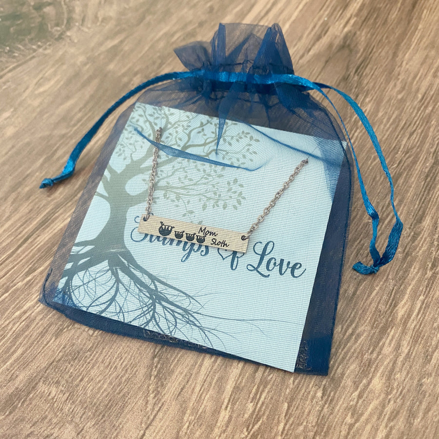 bar necklace on packaging card in blue organza gift bag
