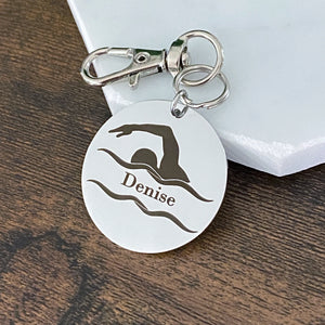 engraved round bag tag with swimmer image and the name Denise