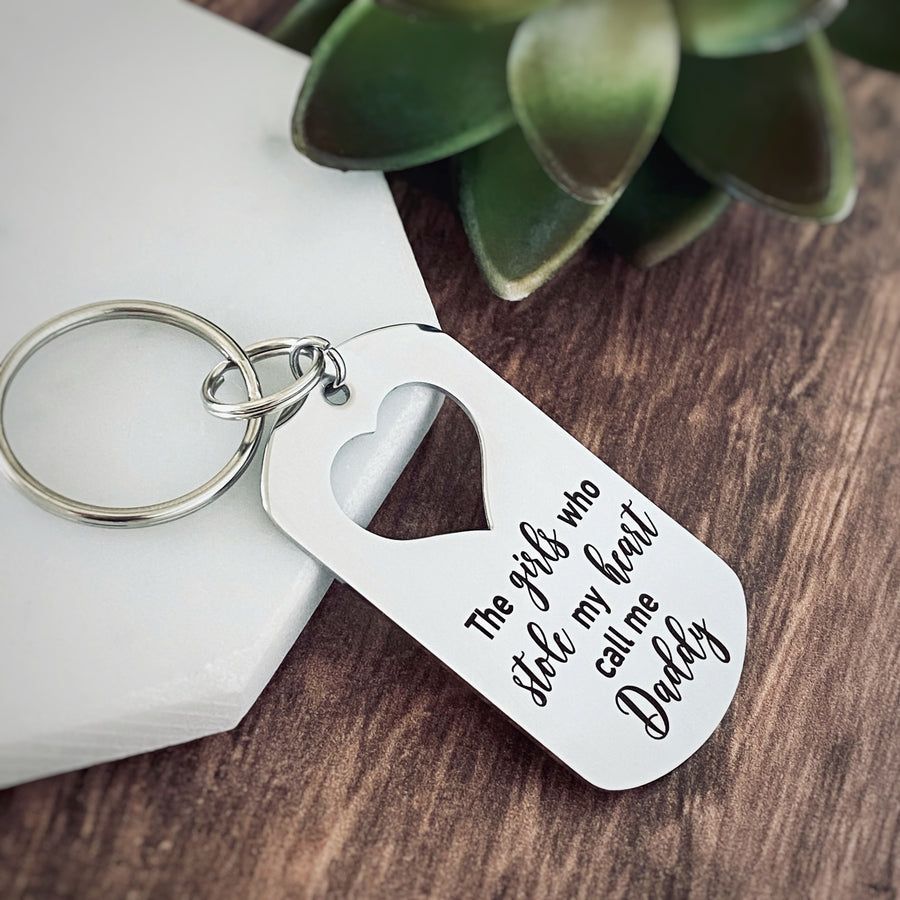 Silver Stainless Steel dog tag keychain engraved with "The girls who stole my heart call me Daddy".