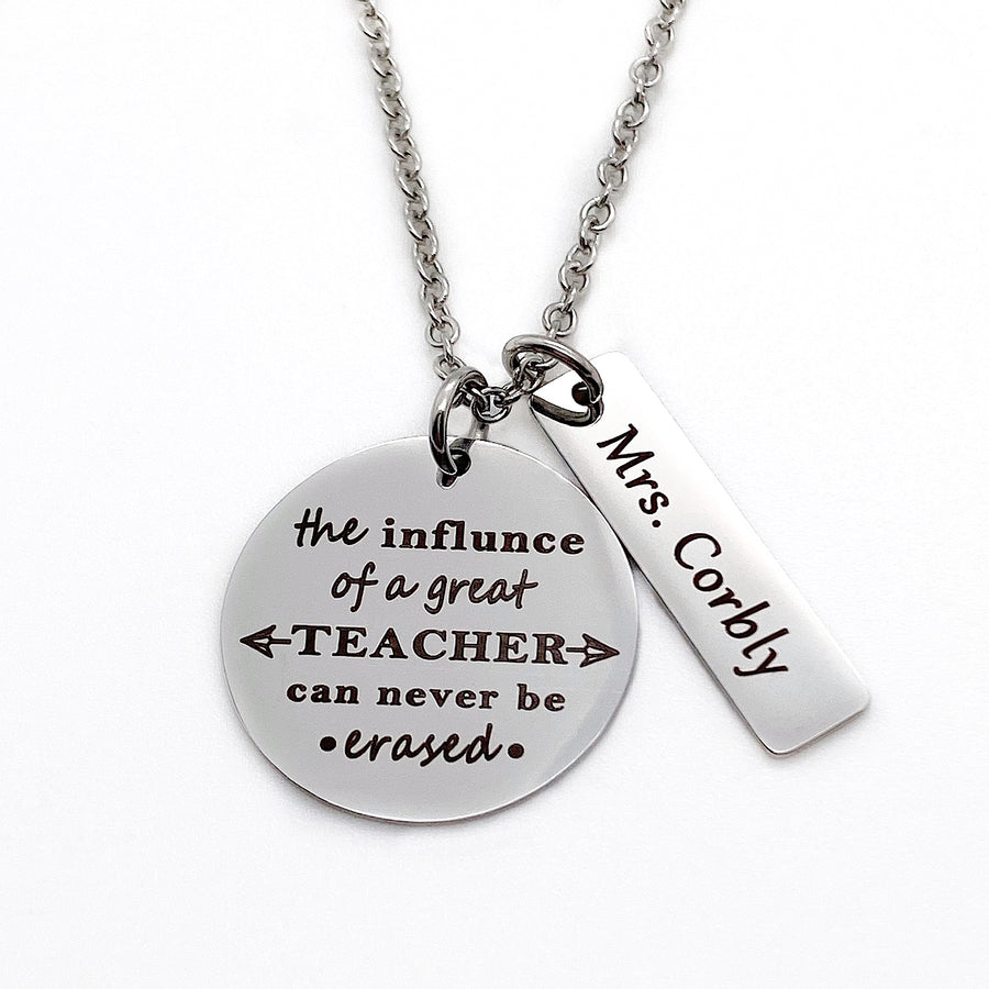 silver stainless steel round engraved pendant with "the influence of a great teacher can never be erased" with a rectangle teacher name tag "Mrs. Corbly"