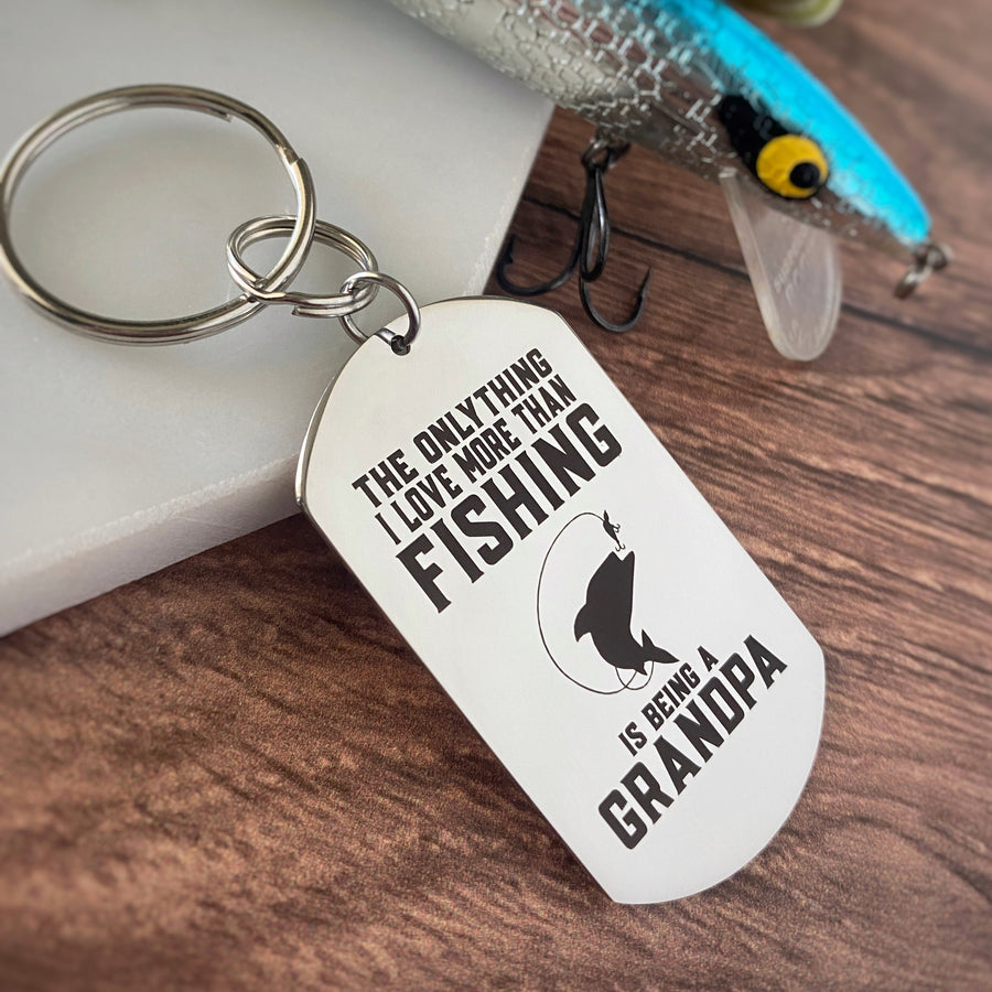 Silver stainless steel dog tag keychain engraved with the phrase, "The only thing i love more than fishing is being a grandpa"