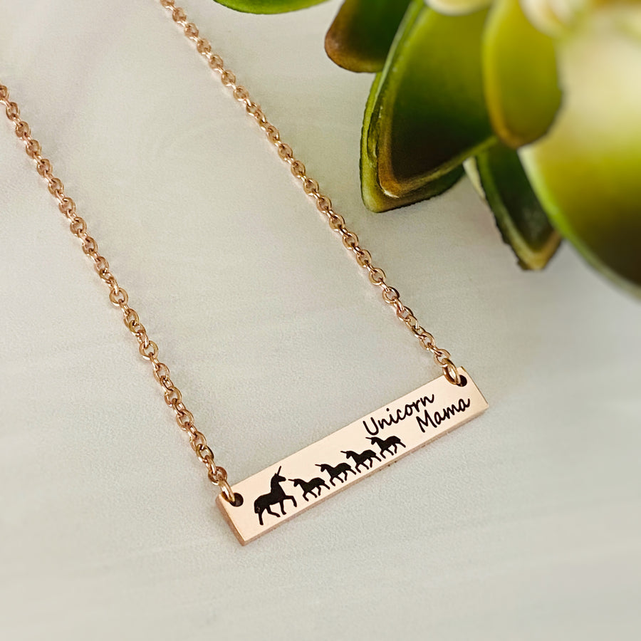 rose gold horizontal bar necklace engraved with a mom unicorn and 4 baby unicorns