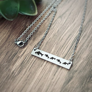 Silver whale bar necklace with 1 mom orca and 4 baby whale cubs on a cable chain with lobster clsp