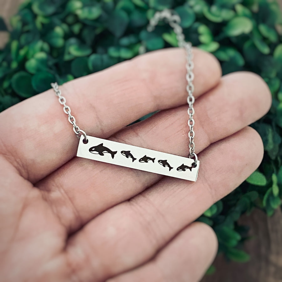 mom whale bar necklace on hand