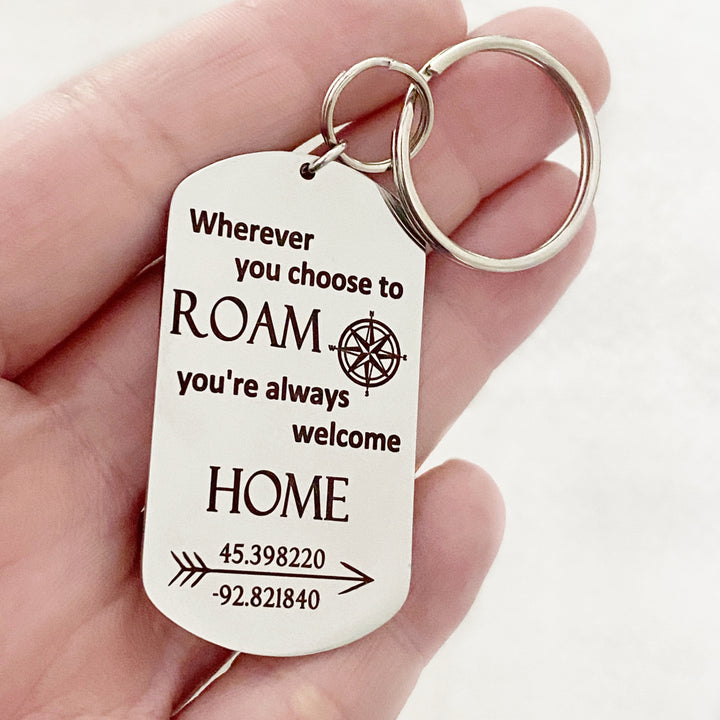 silver dog tag keychain with "wherever you choose to roam you're always welcome home" personalized latitude and longitude location coordinates attached to a triple loop keyring