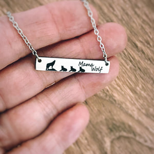 wolf necklace with 3 cubs on womens hand to show size