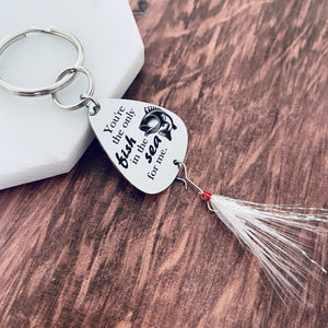 silver stainless steel fishing lure engraved with "Youre he only fish in the sea for me" with an image on a bass fish. The lure is attached to a durable stainless steel split ring attached to a keyring