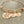 stainless steel rose gold bangle charm bracelet with a 3/4 inch disc engraved with "your first breath took mine away". 1/2 inch name discs with open heart image above the engraved name.