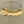 stainless steel yellow gold bangle charm bracelet with a 3/4 inch disc engraved with "your first breath took mine away". 1/2 inch name discs with open heart image above the engraved name.