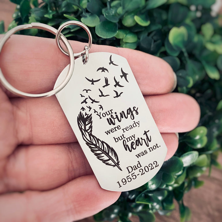 silver engraved memorial keychain with the phrase "Your wings were ready by mom heart was not." with the name "Dad" and the year of birth 1955 and the date of death 2022
