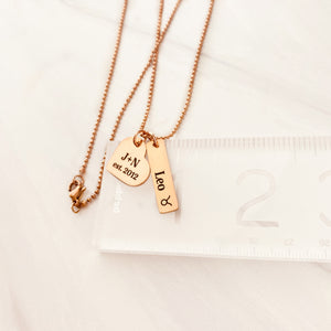 rose gold zodiac necklace on ruler to show measurements