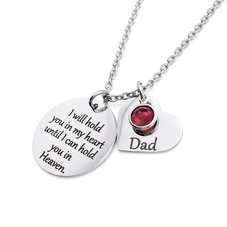 One 1-inch silver stainless steel disc engraved with "I will hold you in my heart until I can hold you in Heaven" Along side is a 3/4" silver heart engraved with "Dad" and a July red birthstone. Both pendants are attached to a stainless steel cable chain with lobster clasp.