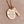 A 1 inch round stainless steel plated rose gold disc engraved with the verbiage "The influence of a great teacher can never be erased." Next to the disc is a 1.2" rectangle engraved with "Mrs. Nelson". The charms are attached to a rose gold cable chain.